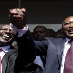 President-elect Kenyatta greets his supporters with his running mate Ruto after attending a news conference in Nairobi
